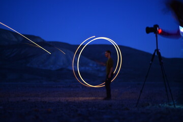 Iron wool circle drawing light fireworks. Burning Steel Wool spinning, Trajectories of burning sparks at night. Movement light effect, steel wool fire hoop. long exposure light painting, Pyrotechnic