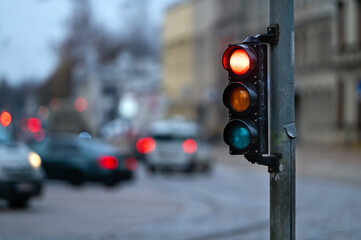 traffic light on the street junction with beautiful bokeh, city with cars in the background