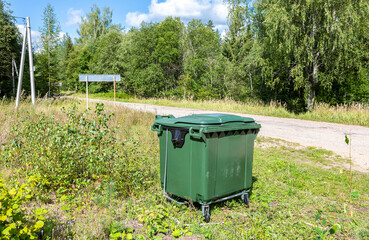 Green plastic garbage container at the outdoors