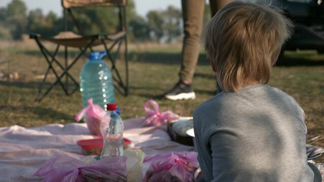 Family with Child Kid Outing Rest Picnic Near Campfire by Lake Countryside Nature Country Rural Summer. 2x Slow motion 60fps 4K
