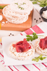 Rice cakes with milk flakes and cold beef.