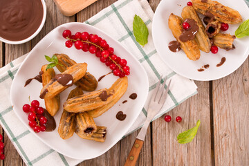 Mini churros with chocolate dipping sauce.