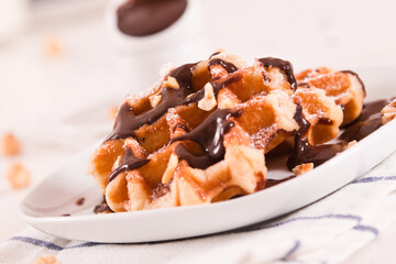 Waffles with chocolate cream and hazelnuts.