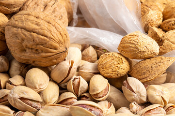 Close up of various nuts in open single-use plastic bags