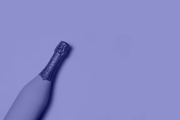 Festive Minimalistic Champagne Bottle on Blue Background. Creative Concept. Very Peri - Color of the year 2022.