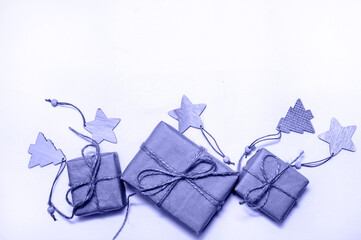 Christmas Composition with Gift Boxes and Decorations on Light Background. Very Peri - trendy color of year 2022