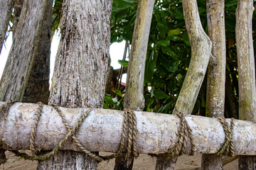 Wooden fence tied with ropes on a tropical island.