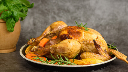 Whole roasted chicken with vegetables. Close up