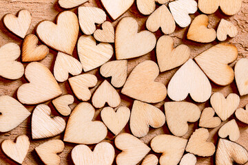 many wooden hearts on a wooden background. top view, close-up. happy Valentine's Day concept