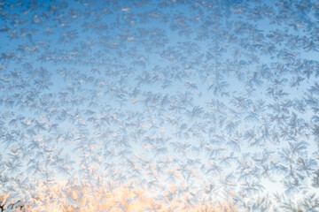 Natural phenomena, Magical frost and ice patterns on a winter glass. Winter decorations, frozen water on the window.