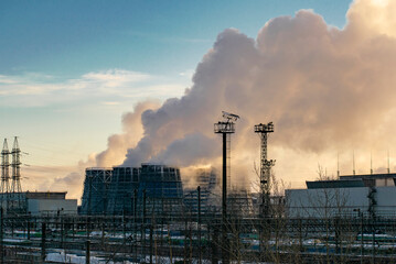 The soaring cooling towers of a huge industrial plant. Ecological concept.