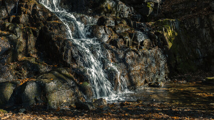 Water runs down the rocks. Autumn.