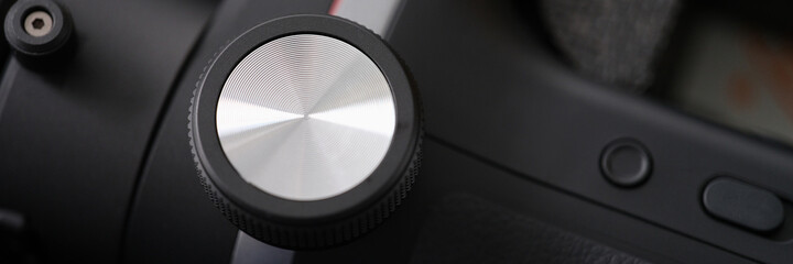 Closeup of metal button on control panel