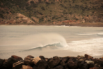 swell during a stormy day and strong winds at Lastre beach in Portman.