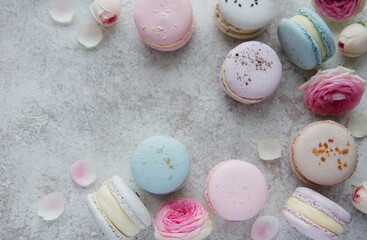 Beautiful colorful tasty macaroons on a concrete background