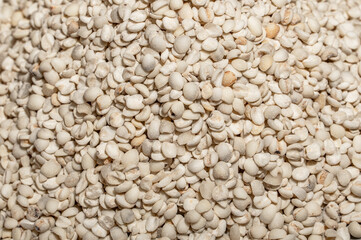 The plate or bowl on the wood grain table contains job's tears