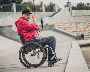 Person with a physical disability in a wheelchair fishing from fishing pier.