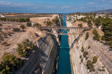 Aerial view of a deep narrow Corinth channel with blue water cut through the rock, Korinthos, Greece