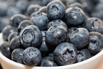 ripe juicy and tasty blueberries in large quantities on a wooden table