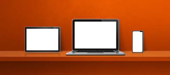 Laptop, mobile phone and digital tablet pc on orange wall shelf. Banner background
