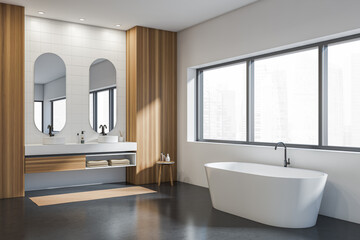 Fototapeta na wymiar Light wooden bathroom interior with bathtub, sinks and panoramic window