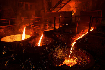 A jet of molten steel is poured into ladles. Metallurgical industry