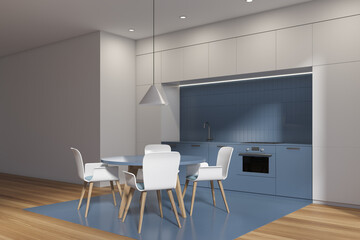 White and blue kitchen interior with table and chairs, wooden floor