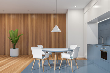 White and blue kitchen interior with table and chairs, wooden floor