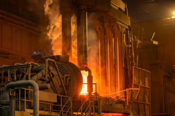 Electric arc furnace during operation. Lots of smoke and fire