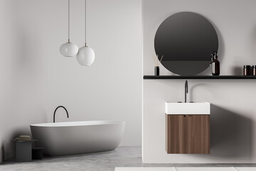 White bathroom interior with sink and mirror, bathtub and lamp