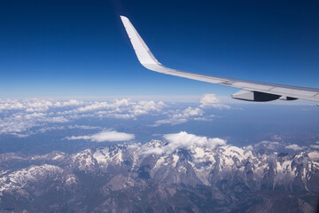 Obraz premium Airplane wing view on a summer sunny day with the Mont Blanc mountain area below