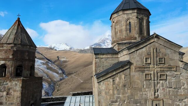 Aerial Drone Shot of Gergeti Trinity Monastery Kazbegi Georgia with Beautiful Mountains