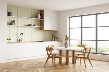 Light kitchen set interior with dining table and chairs, kitchenware and window