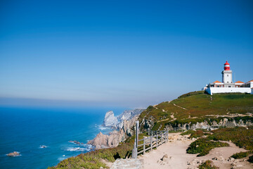 Fototapeta na wymiar View of Cabo da Roca Lighthouse. Portuguese Farol de Cabo da Roca is a cape which forms the westernmost point Eurasian land mass.