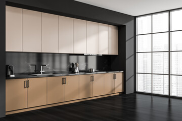 Corner view of beige and black kitchen cabinet