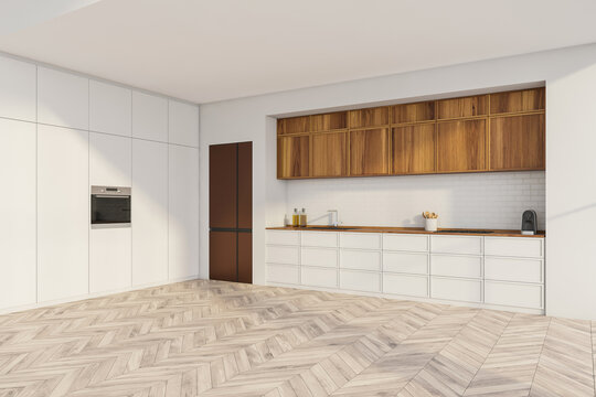 White and wood kitchen with integrated equipment. Corner view.