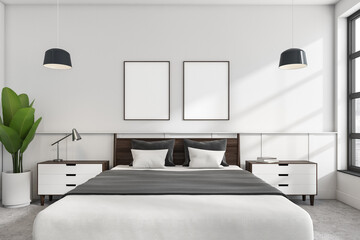 White bedroom interior with bed, linens and window, mockup posters