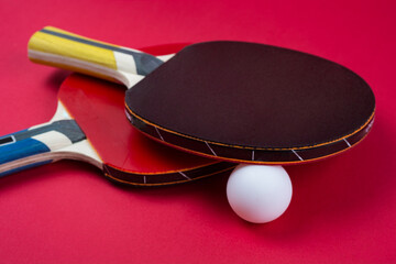 Pair of red ping-pong rackets and white ball, isolated on white background