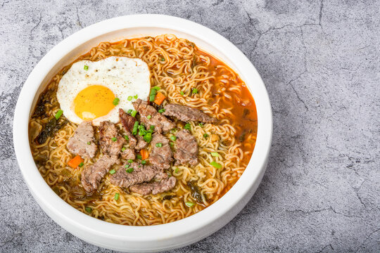 A basin of Korean instant noodles on a white background