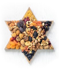 Mix of dried fruits and nuts - symbols of judaic holiday Tu Bishvat. Star of David . White wood texture background .