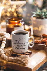 Lifestyle. A cup of tea on a wooden table during the Christmas holidays. The inscription on the mug in Russian: do what you want. Still-life. The concept of home warmth, comfort.