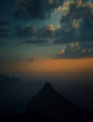 Teal and orange trek view from an indian mountain range, beautiful moody sky with clouds