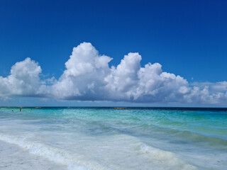 Beautiful, exotic and natural tropical landscape, beach with white sand. Turquoise Indian Ocean on background blue sky with white big clouds on sunny summer day, Zanzibar Island, Afica, Nungwi, Kiweng