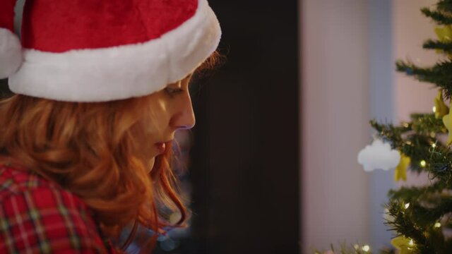 Giovane ragazza sistema l'albero di Natale