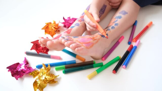 Funny cute bare feet. Child painting coloring feet