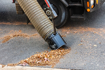 Street cleaning Leaf vacuum cleaning up autumn leaves