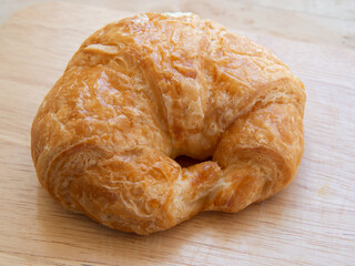 Croissant bread on a wooden plate