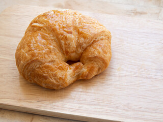 Croissant bread on a wooden plate