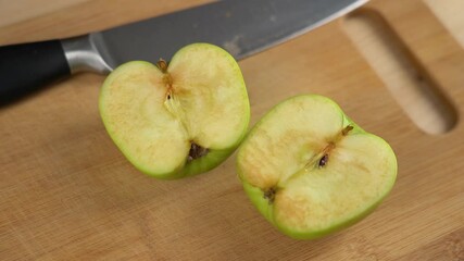 Time lapse green apple cut into half and oxidised. Turning from fresh apple into oxidised brown apple. Wooden table background