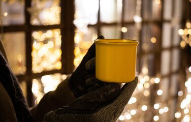 woman holding mug with hot drink at Christmas market